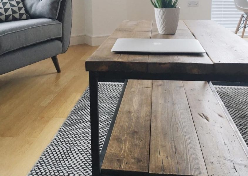 Close up of industrial reclaimed wood coffee table on grey rug