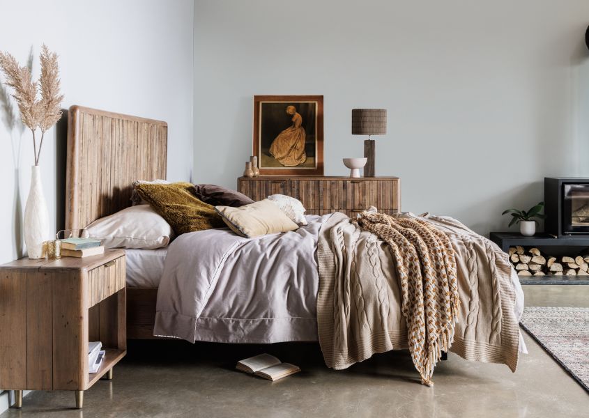 farmhouse bedroom with solid wood bed and wooden bed table