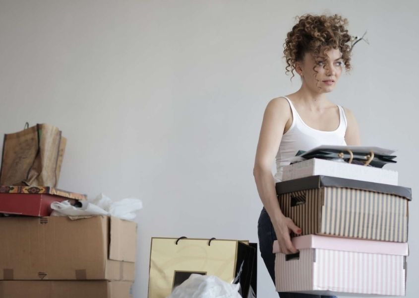 woman carrying boxes for organise an end of summer clear out blog