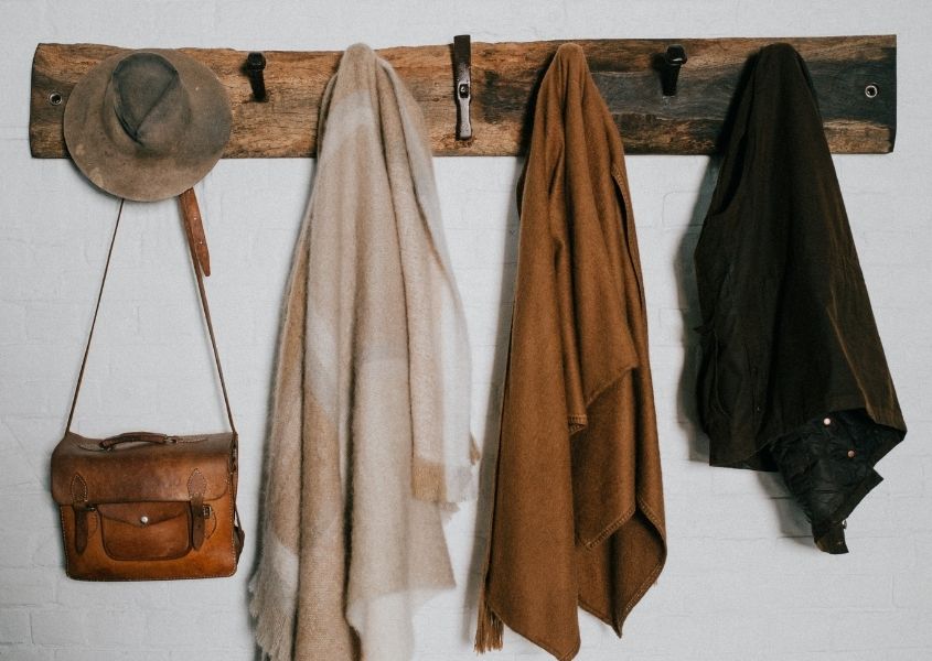 coats and bags on rustic wooden rack