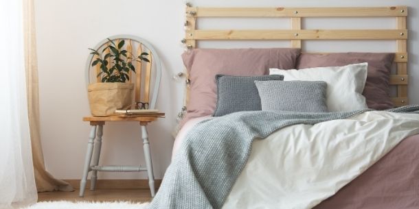 Wooden bed with palette headboard