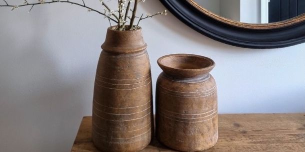 Terracotta vases on rustic console table