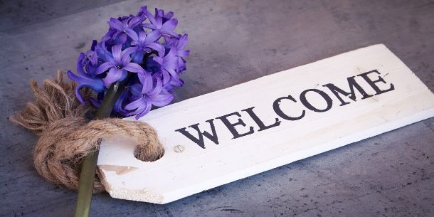 Wooden sign with welcome written on it