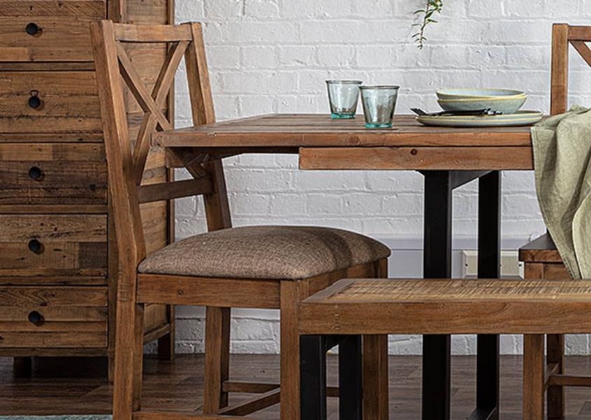 Reclaimed wood dining chair next to industrial dining table
