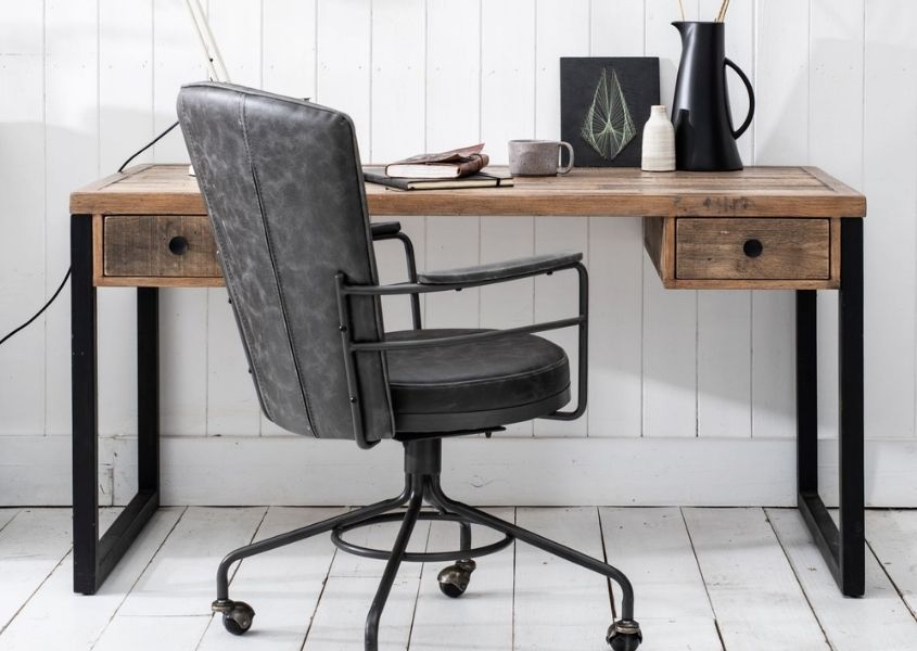 industrial desk with black steel legs, two drawers and grey faux leather office chair