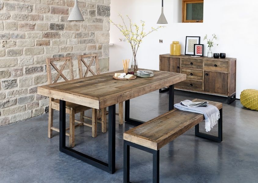 Industrial dining table with wooden bench and reclaimed wood chairs