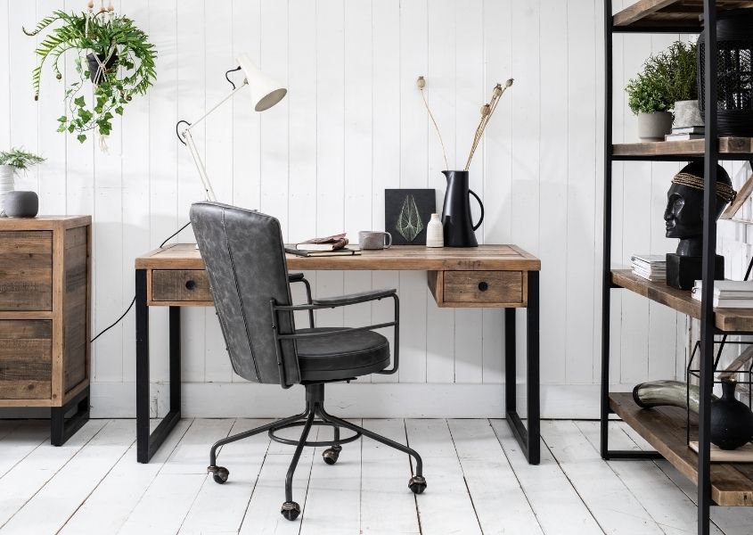 Industrial office desk with grey faux leather best office chair and wooden bookcase