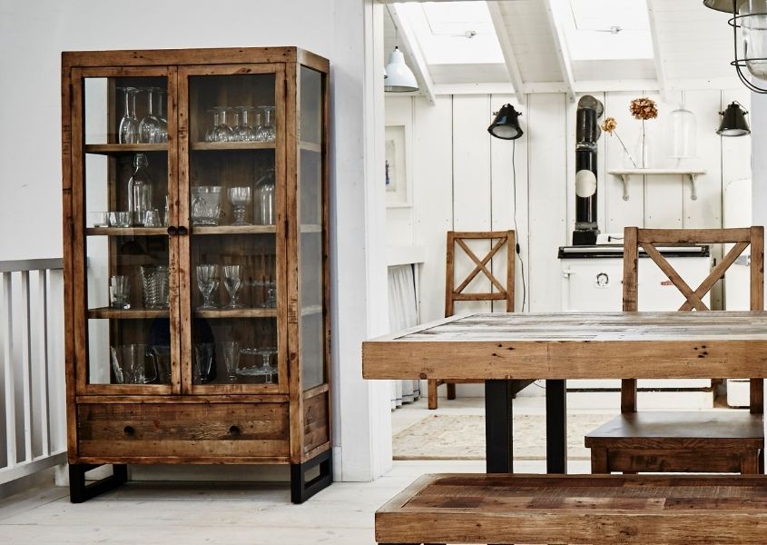 Reclaimed wood glass cabinet in dining room with rustic dining table