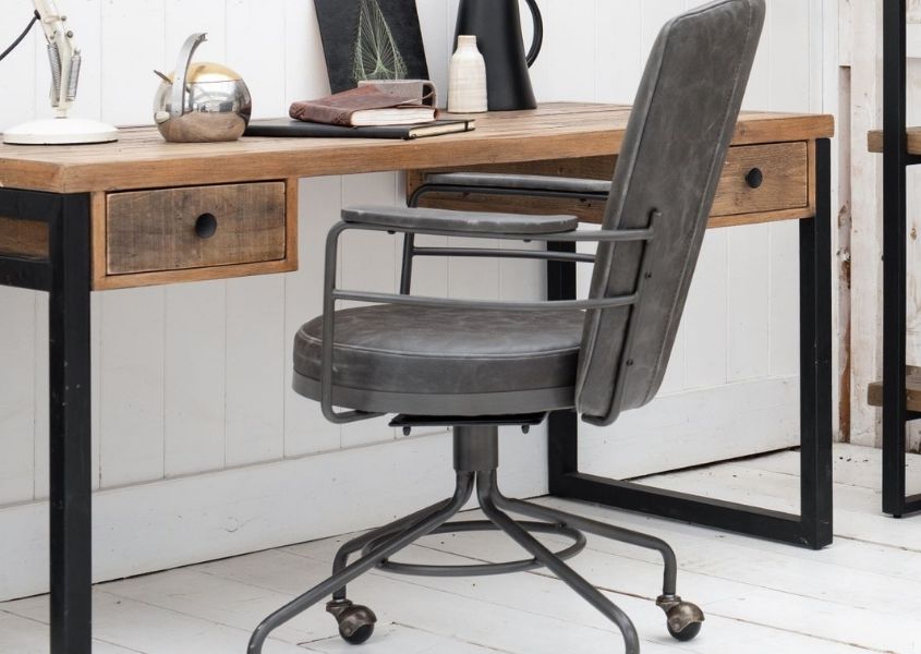 grey faux leather desk chair next to industrial desk