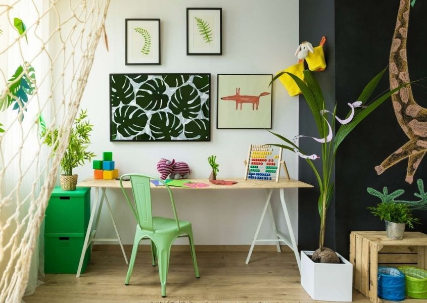 children's study area with green metal chair and wooden desk