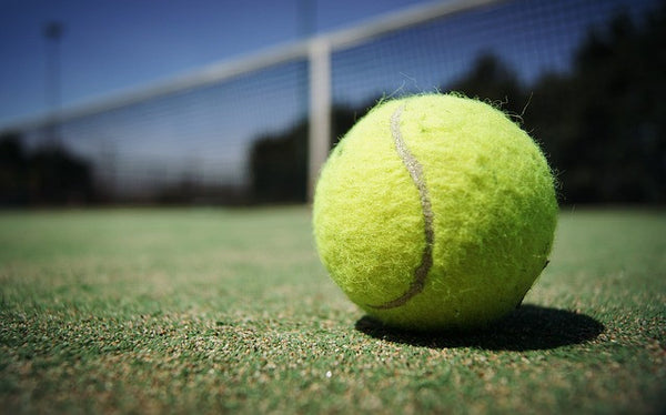 Wimbledon tennis ball in court