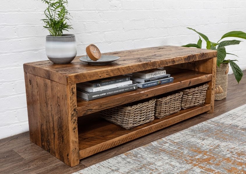 Reclaimed wood coffee table with middle shelf and three wicker baskets on lower shelf