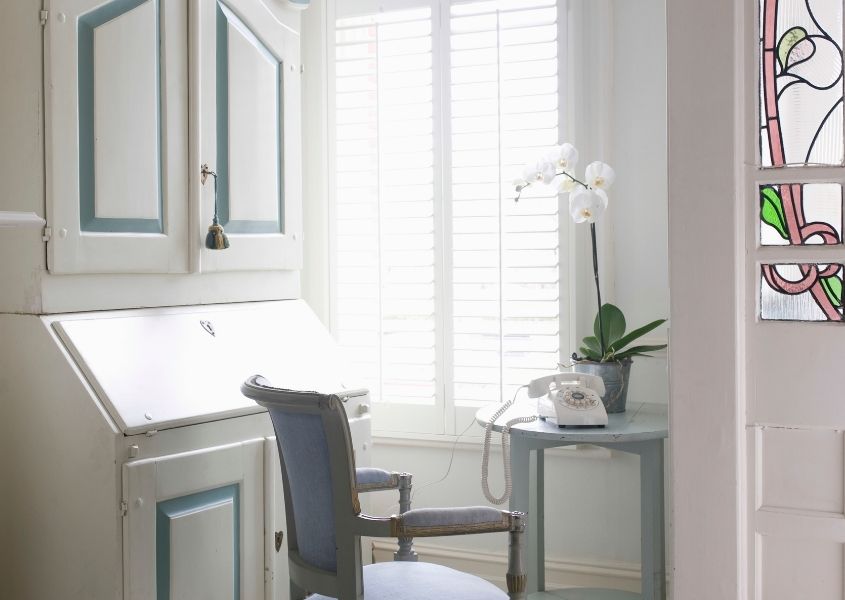 white and blue writing bureau with blue dining chair