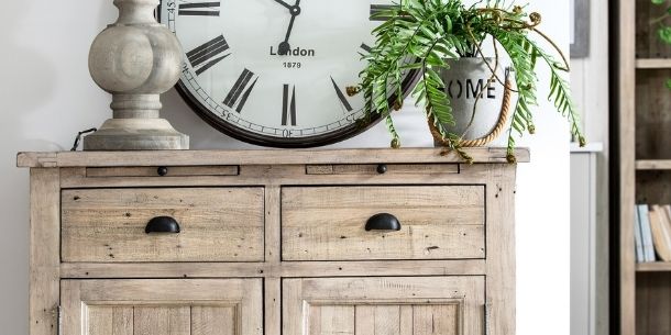 Top of a reclaimed wood sideboard with large clock