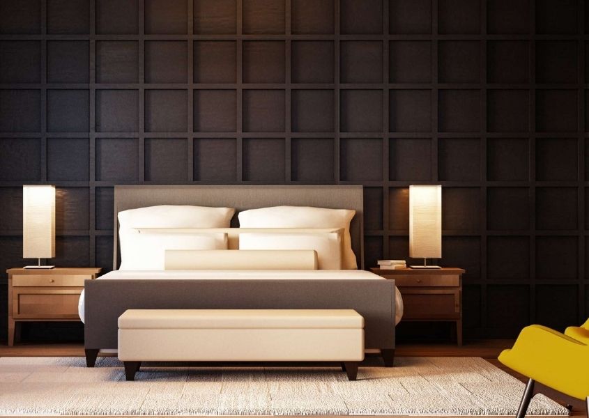 fabric king size bed frame against dark painted wood panelled wall