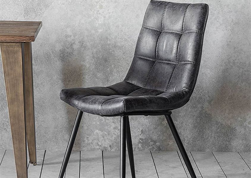 Grey faux leather dining chair with industrial style legs