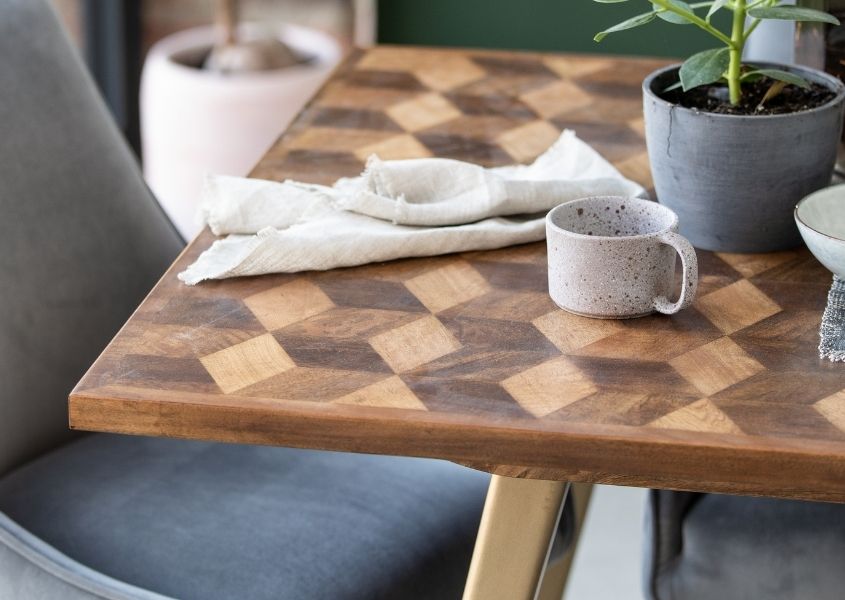 top of mango wood dining table with cup and napkin
