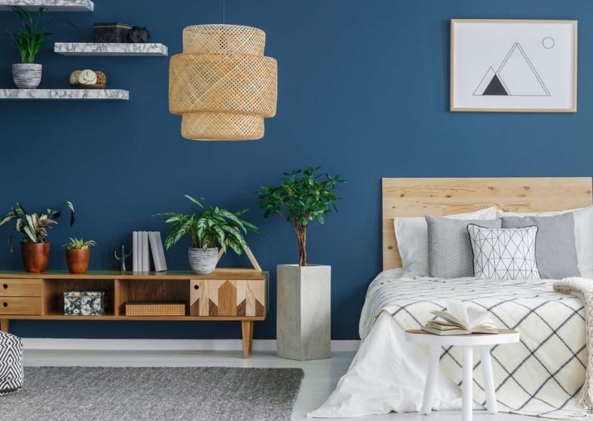 bedroom with blue wall and double wooden bed frame