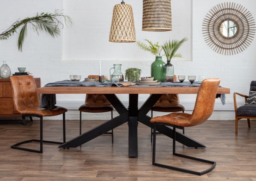 industrial oak dining table with black steel spider leg and tan leather dining chairs