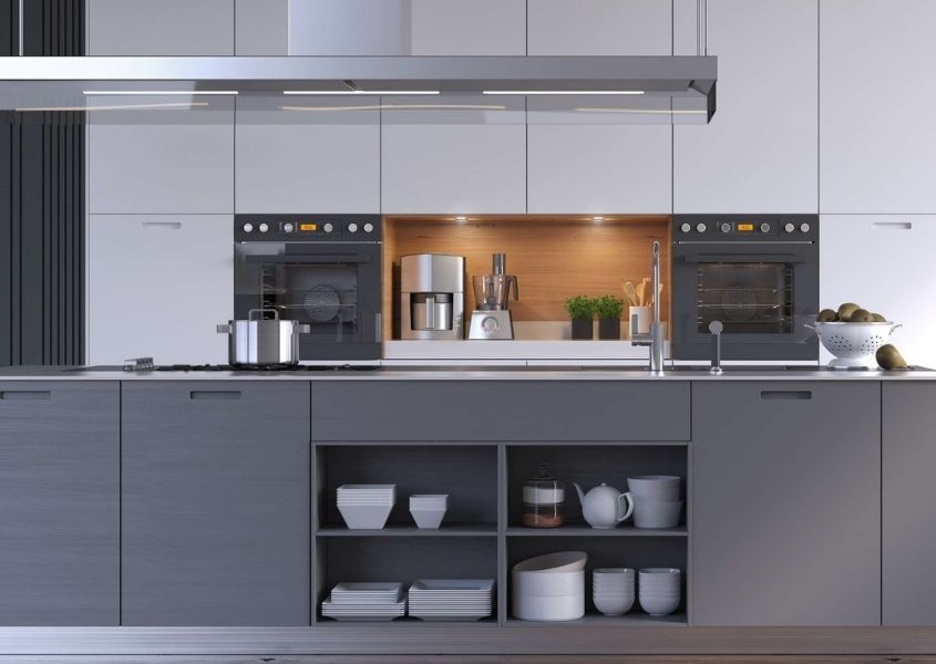 Contemporary kitchen with dark grey units and tall white kitchen units with long modern extractor fan