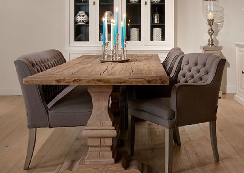 Reclaimed wood dining table with pedestal leg and grey fabric armchairs