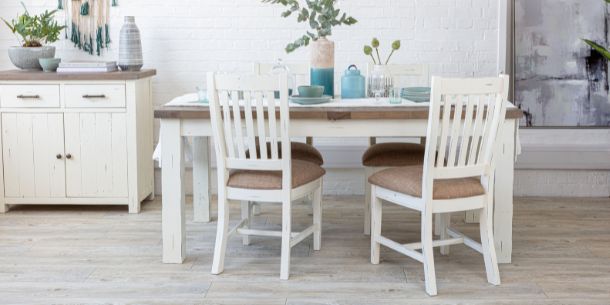White wooden dining chairs with reclaimed wood dining table