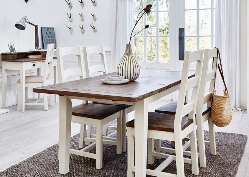 White wooden dining table with natural top and matching chairs with white wooden desk in background